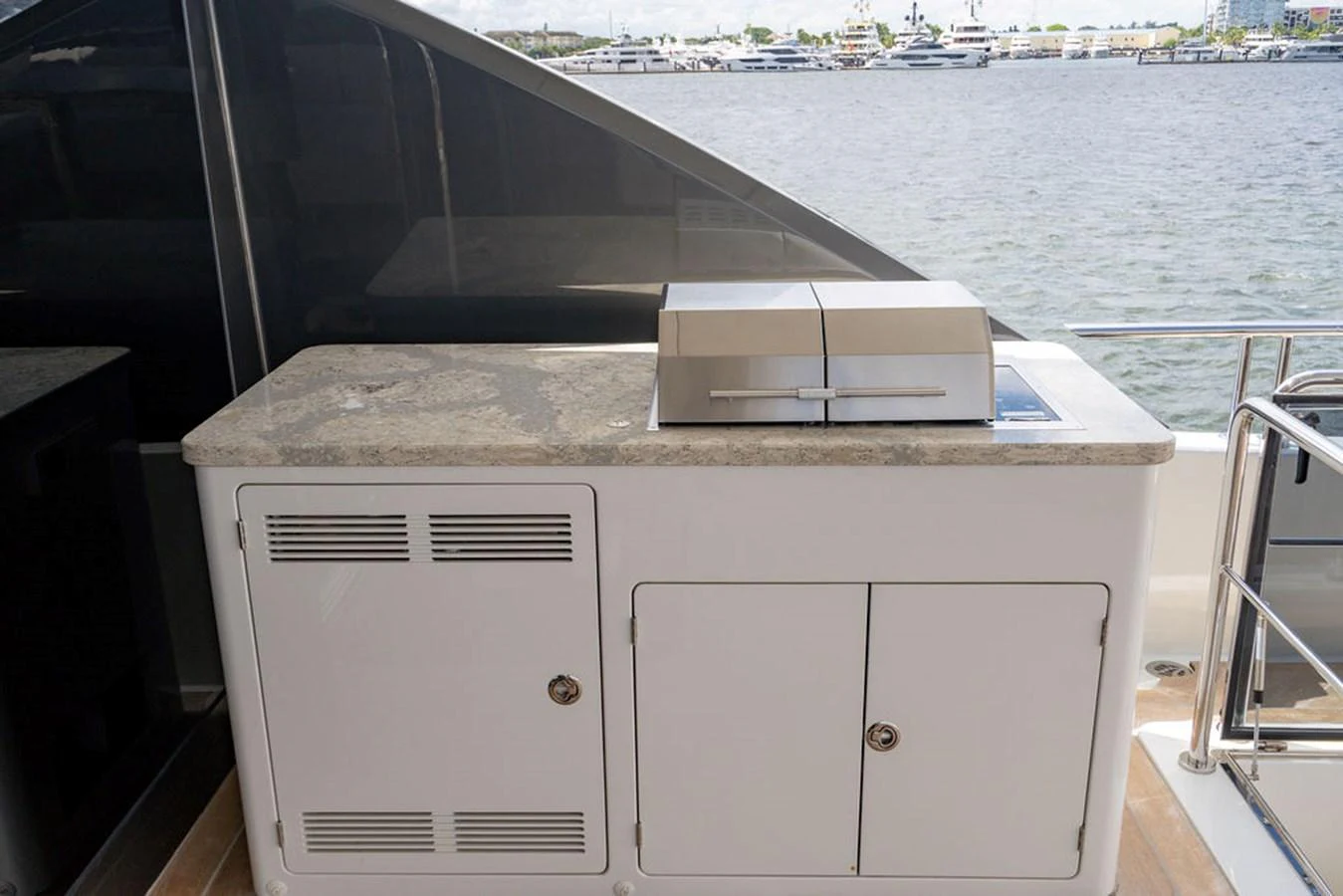 The yacht features a sleek outdoor galley with a built-in grill, perfect for alfresco dining. aboard M/Y 12 Yacht for Sale