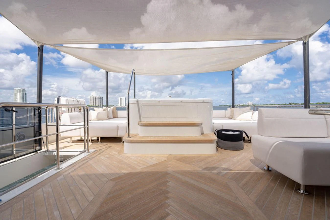 The sundeck offers a spacious and elegant area for relaxation with ample seating and a shaded canopy. aboard M/Y 12 Yacht for Sale