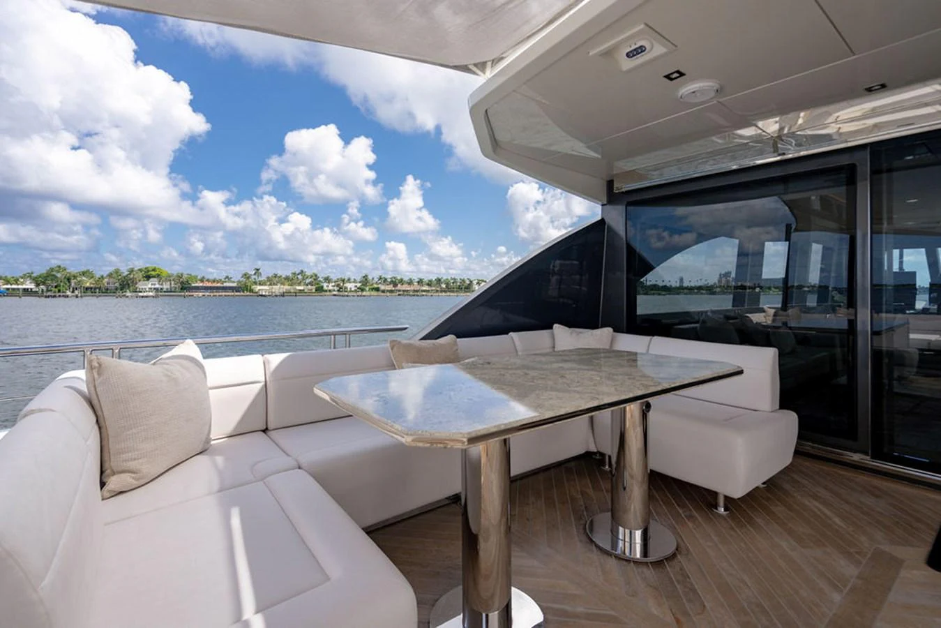 The aft deck features a luxurious seating area with a table, perfect for enjoying scenic views. aboard M/Y 12 Yacht for Sale