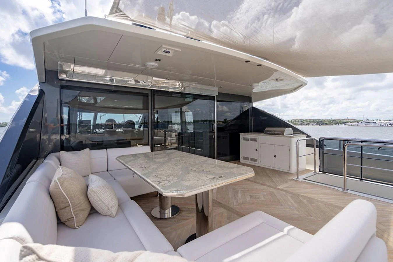 The flybridge offers a luxurious outdoor seating area with a marble table and panoramic views. aboard M/Y 12 Yacht for Sale