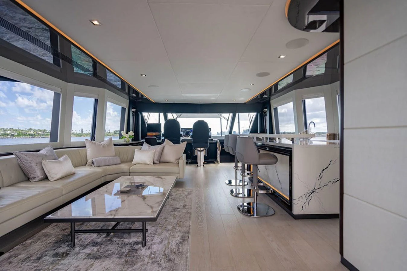 The salon features a spacious seating area with a modern design and panoramic windows. aboard M/Y 12 Yacht for Sale