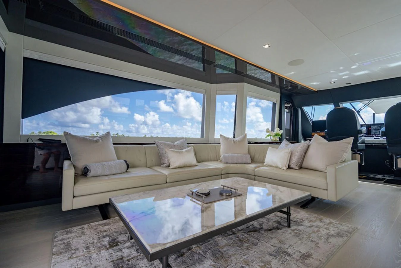 The salon features a spacious and elegant seating area with large windows offering stunning views. aboard M/Y 12 Yacht for Sale