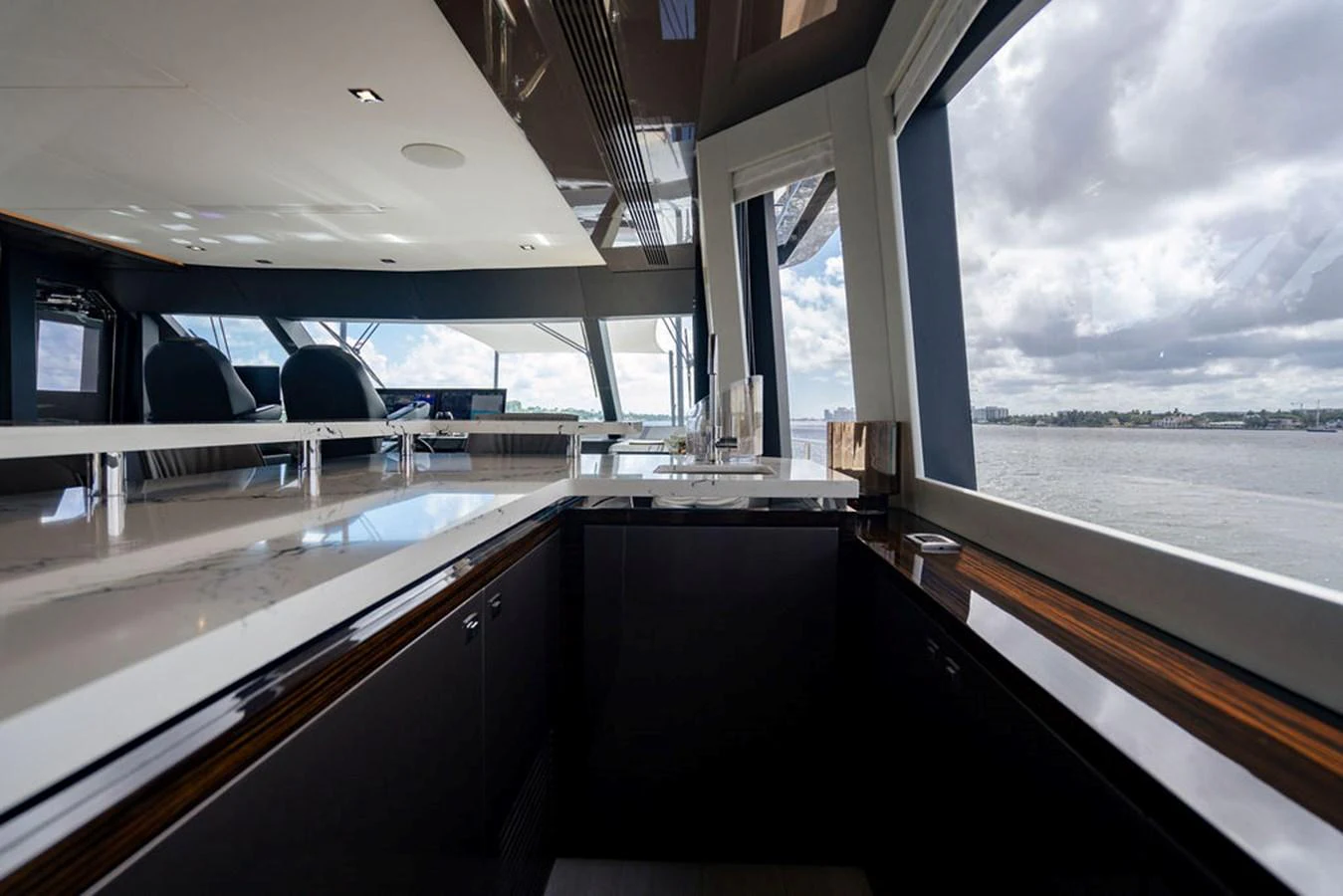 The yacht's galley offers a sleek and modern design with expansive windows providing stunning water views. aboard M/Y 12 Yacht for Sale