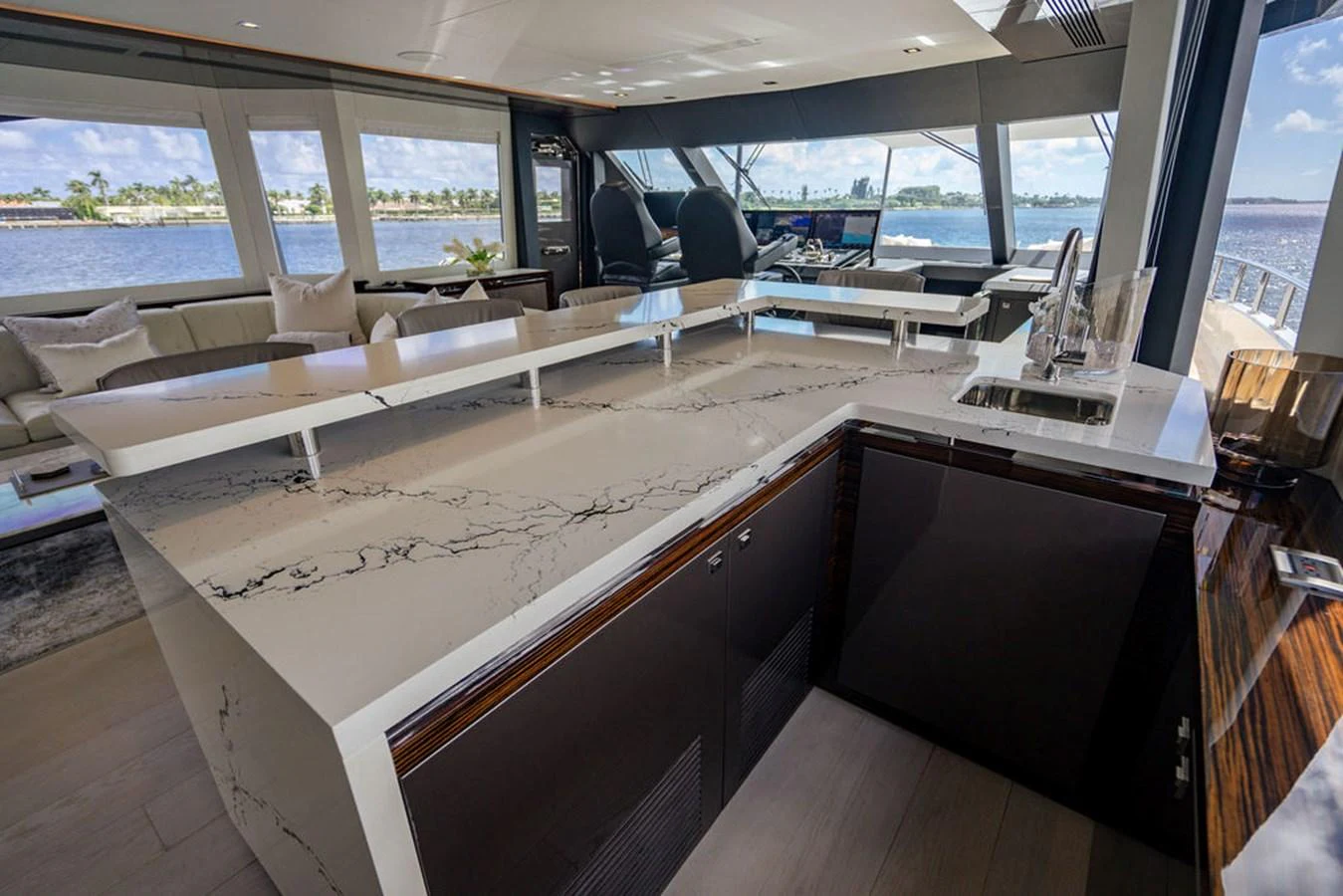 The yacht's galley features a sleek, modern design with a spacious countertop and panoramic windows offering stunning views. aboard M/Y 12 Yacht for Sale