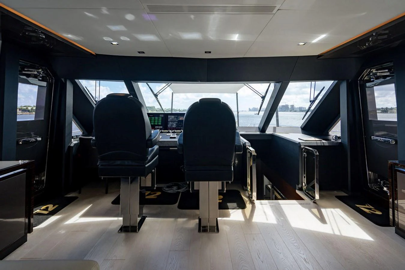 The helm station offers a commanding view with modern navigation equipment and luxurious seating. aboard M/Y 12 Yacht for Sale