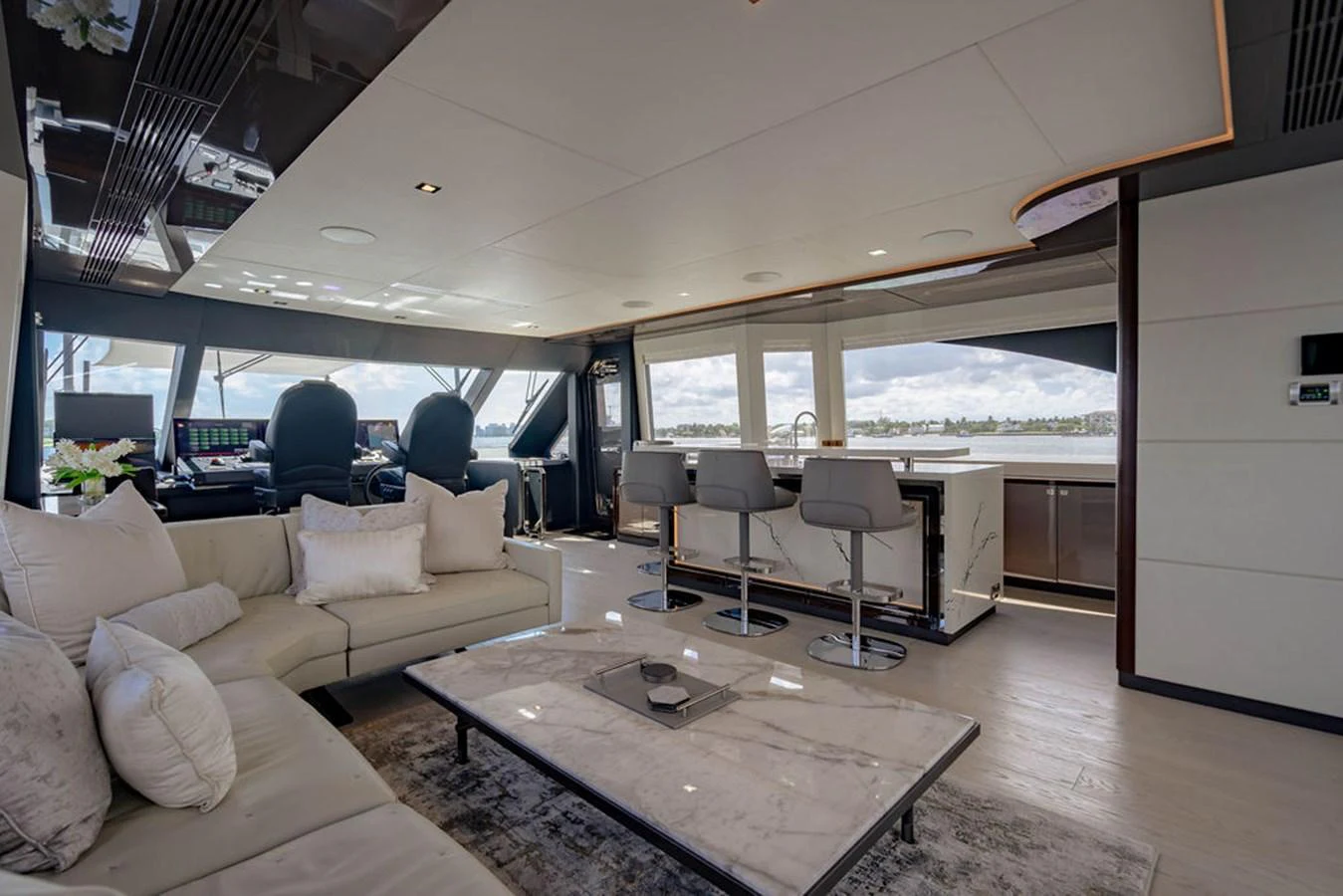 The salon features a spacious seating area with a modern, open layout and large windows offering panoramic views. aboard M/Y 12 Yacht for Sale
