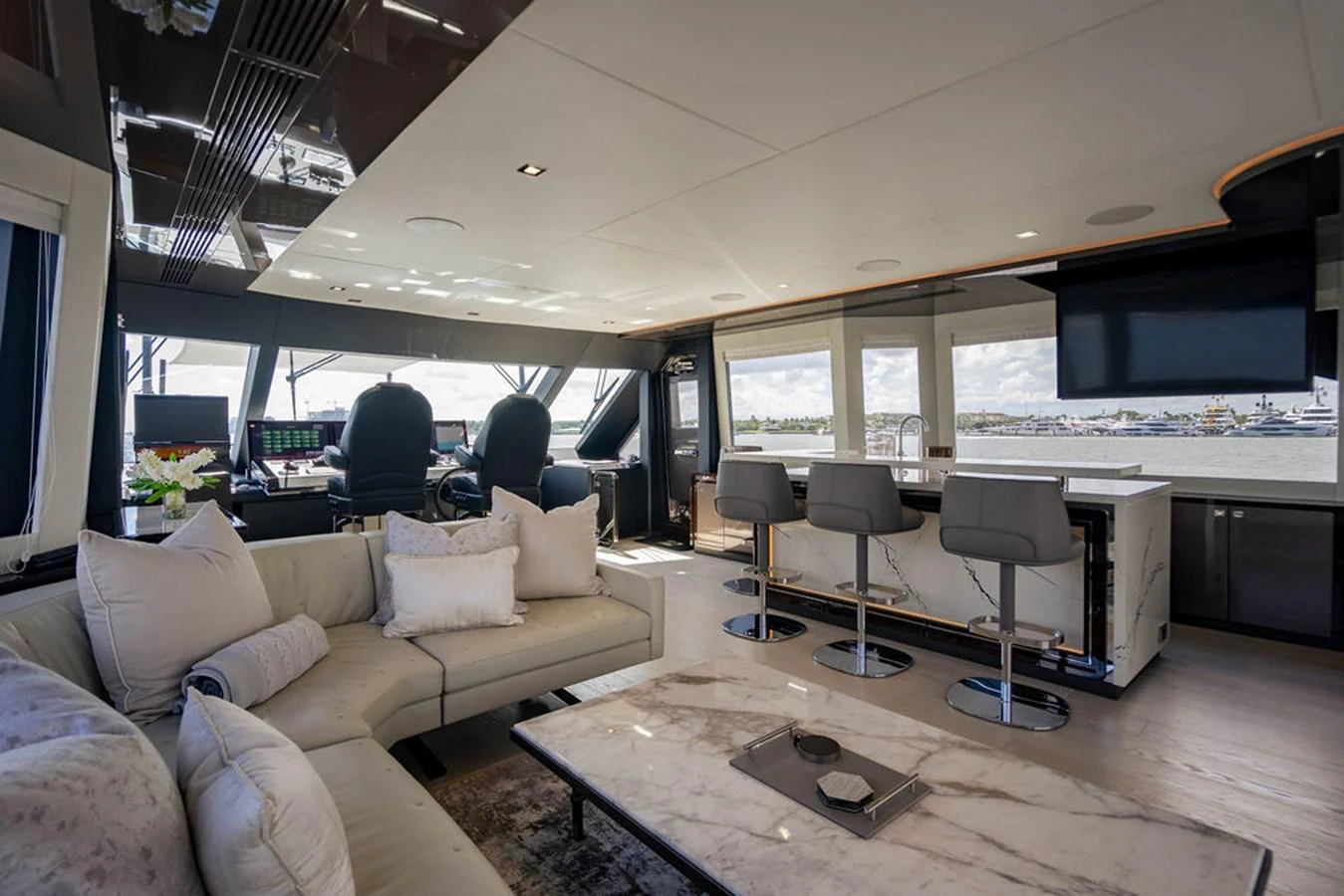 The spacious salon features luxurious seating, a modern entertainment system, and panoramic windows offering stunning views. aboard M/Y 12 Yacht for Sale