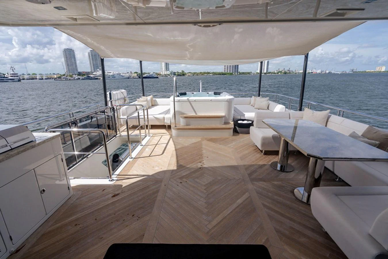 The aft deck offers a spacious and luxurious area with comfortable seating and a dining table, perfect for enjoying the view. aboard M/Y 12 Yacht for Sale