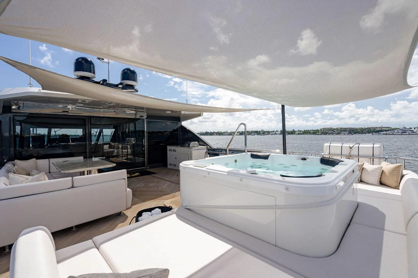 The sundeck features a luxurious jacuzzi and ample seating under a stylish canopy, offering a perfect spot for relaxation with stunning views. aboard M/Y 12 Yacht for Sale