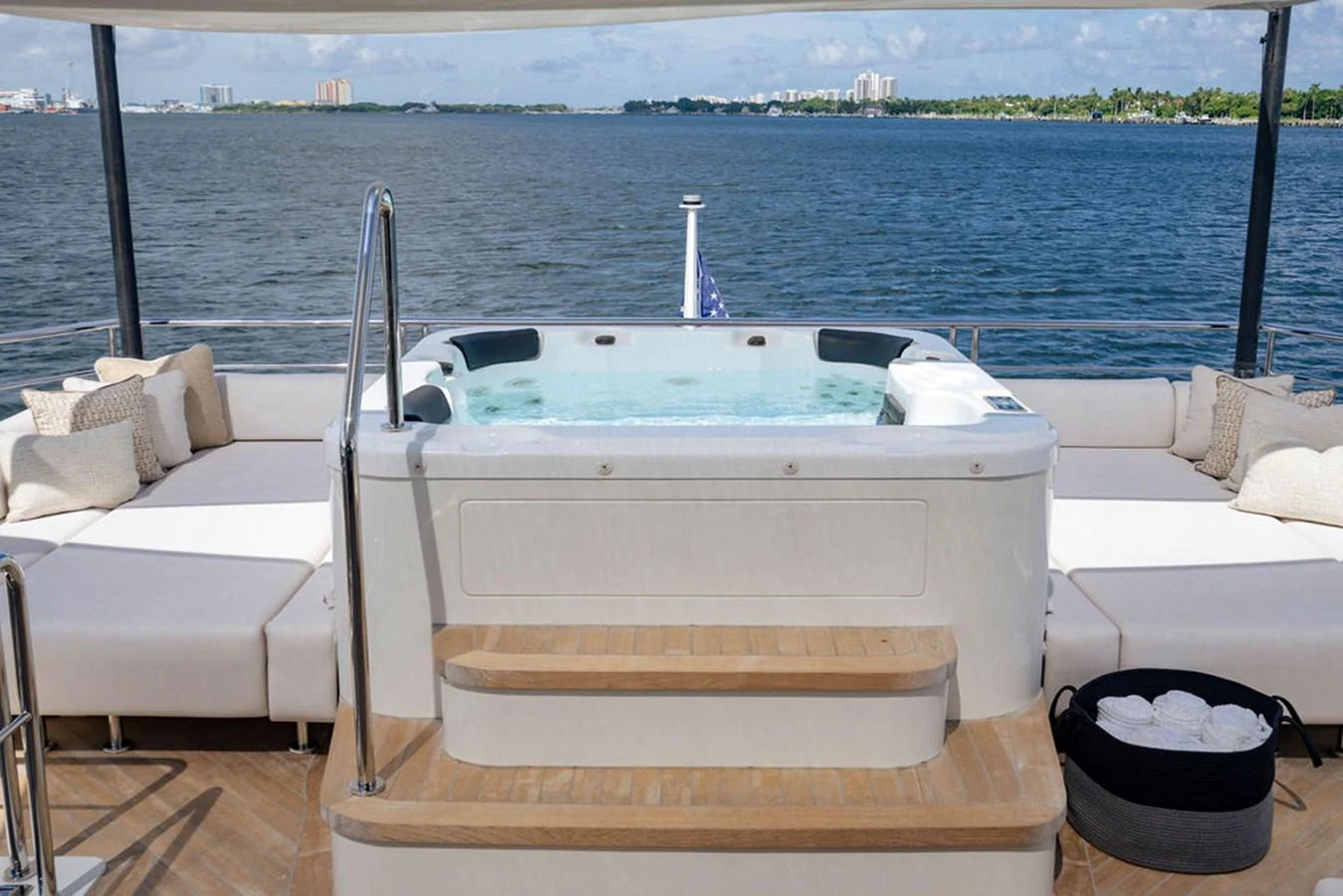 The sundeck features a luxurious hot tub surrounded by comfortable seating with a stunning ocean view. aboard M/Y 12 Yacht for Sale