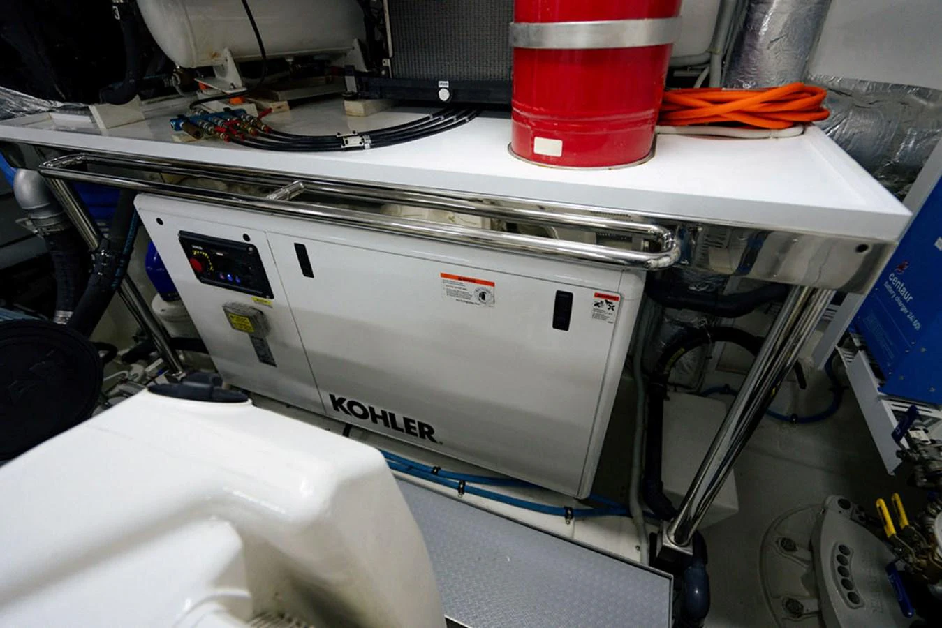 The image showcases the yacht's engine room with a Kohler generator and various equipment. aboard M/Y 12 Yacht for Sale