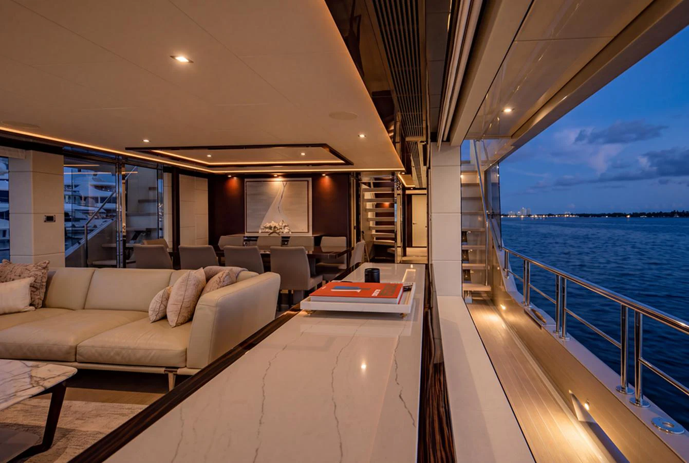 The salon offers a luxurious and spacious area with elegant furnishings and a stunning view of the sea. aboard M/Y 12 Yacht for Sale