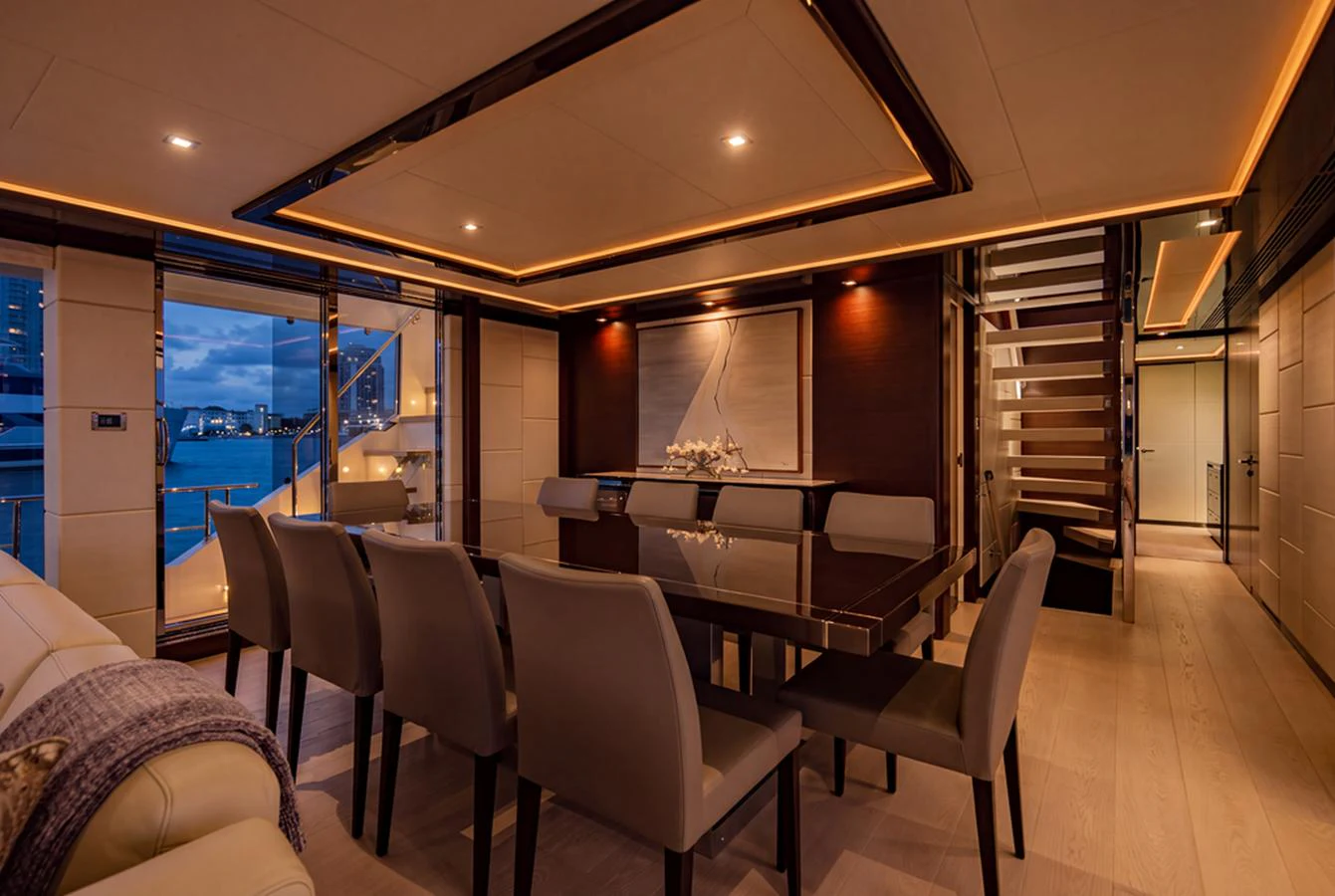 The elegant dining area features a sleek table and comfortable seating, illuminated by soft ambient lighting. aboard M/Y 12 Yacht for Sale