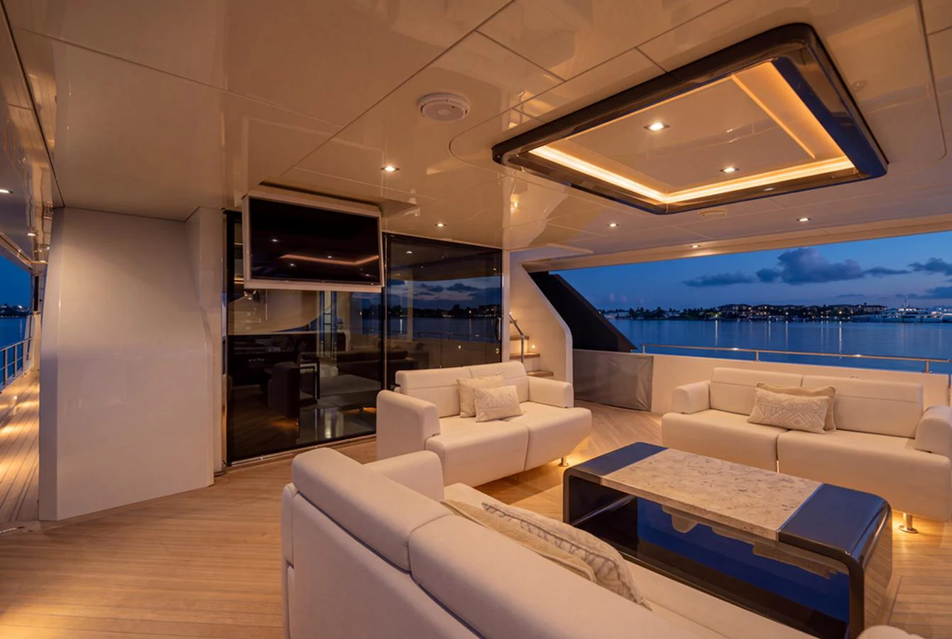 The aft deck features luxurious seating with ambient lighting and a stunning view of the water. aboard M/Y 12 Yacht for Sale