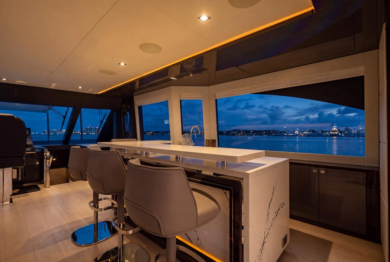 The salon offers a luxurious and modern space with panoramic views of the water. aboard M/Y 12 Yacht for Sale