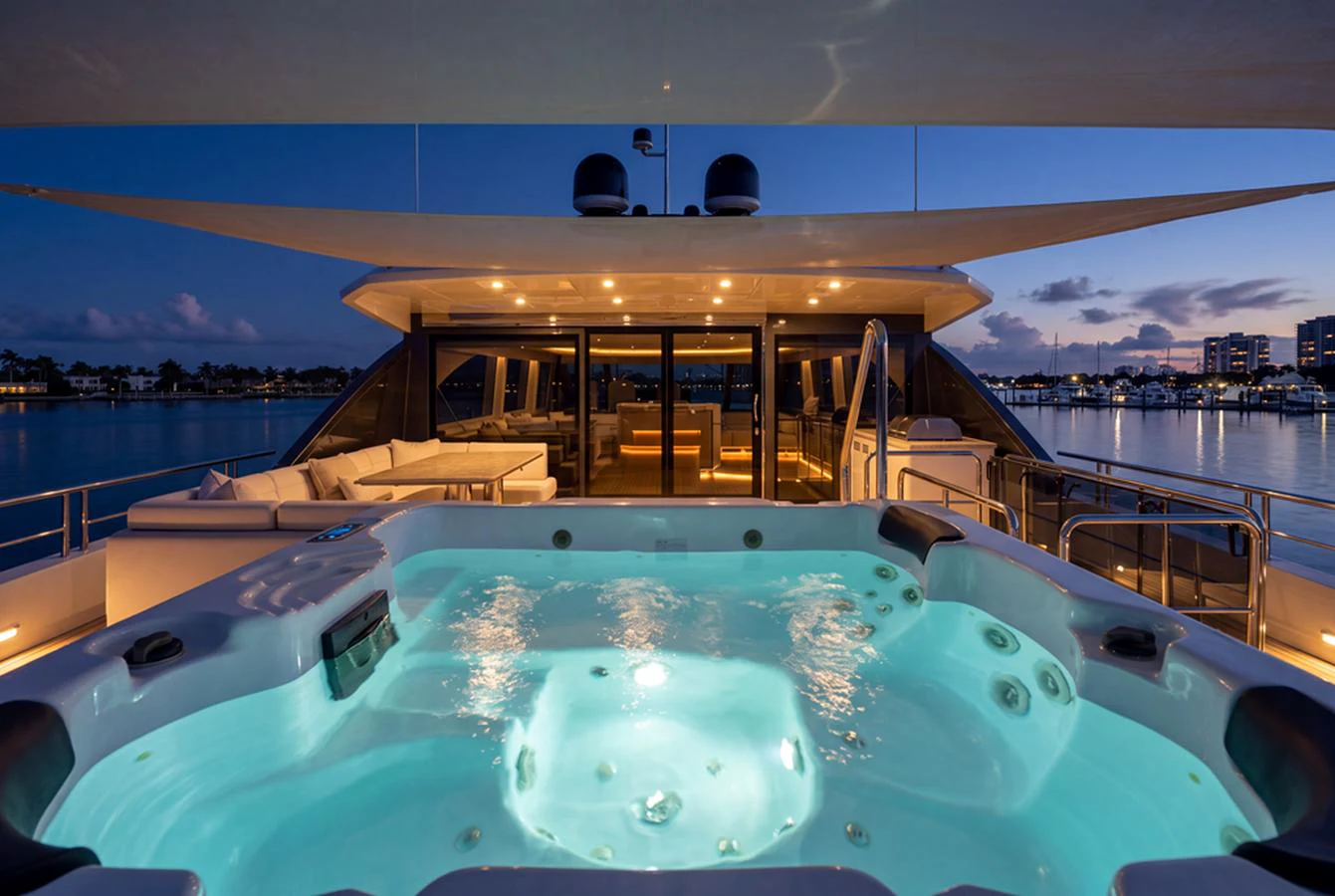 The sundeck features a luxurious jacuzzi with a stunning view of the evening skyline. aboard M/Y 12 Yacht for Sale