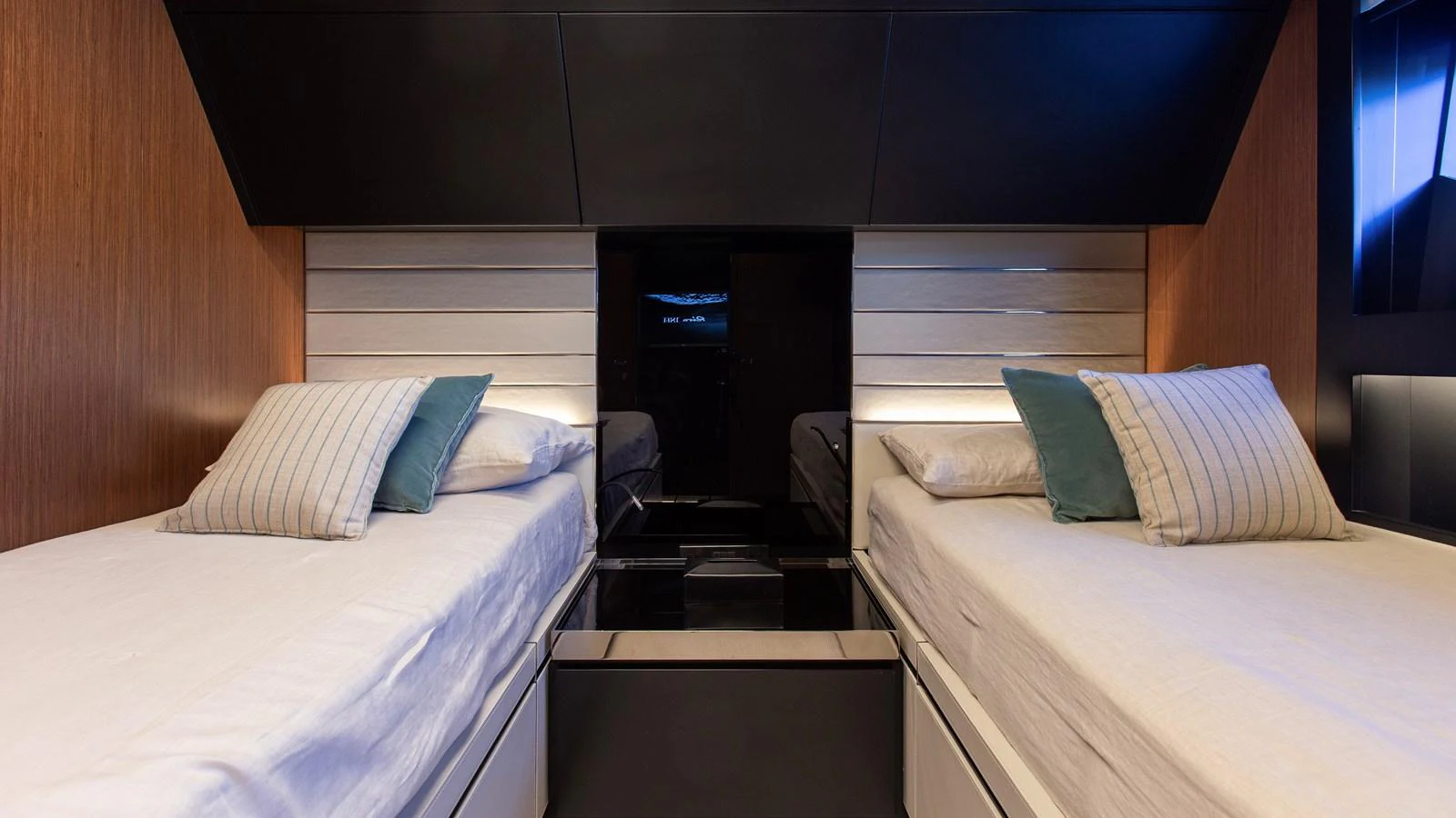 The twin stateroom features two comfortable single beds with elegant bedding and modern design elements. aboard GIO4 Yacht for Sale
