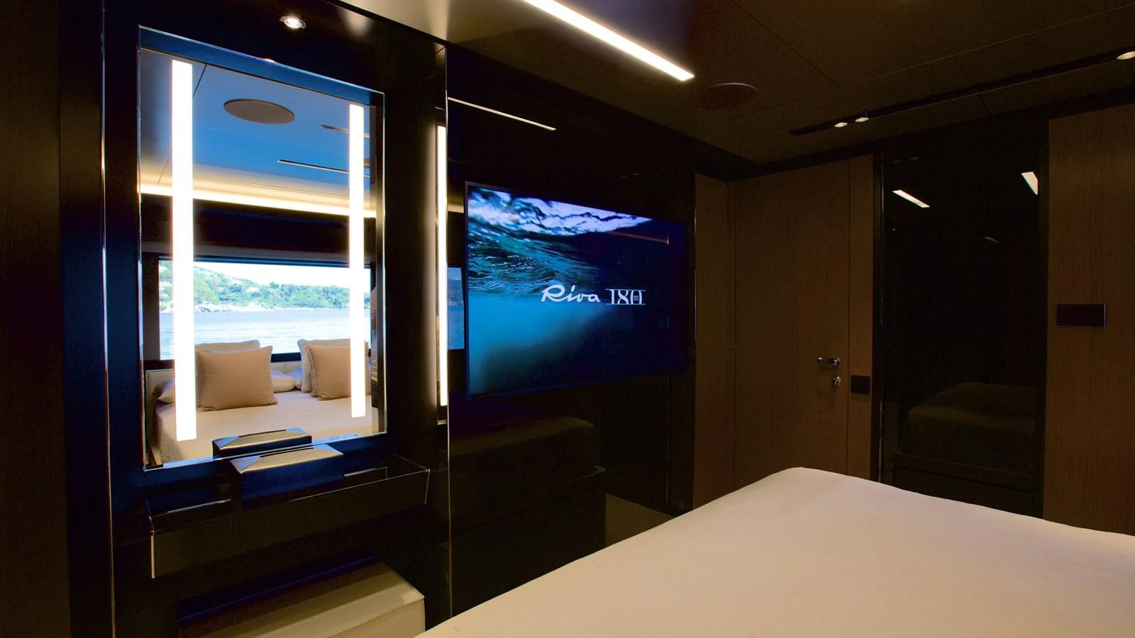 The stateroom features a luxurious bed and a large television, creating a cozy and modern retreat. aboard GIO4 Yacht for Sale