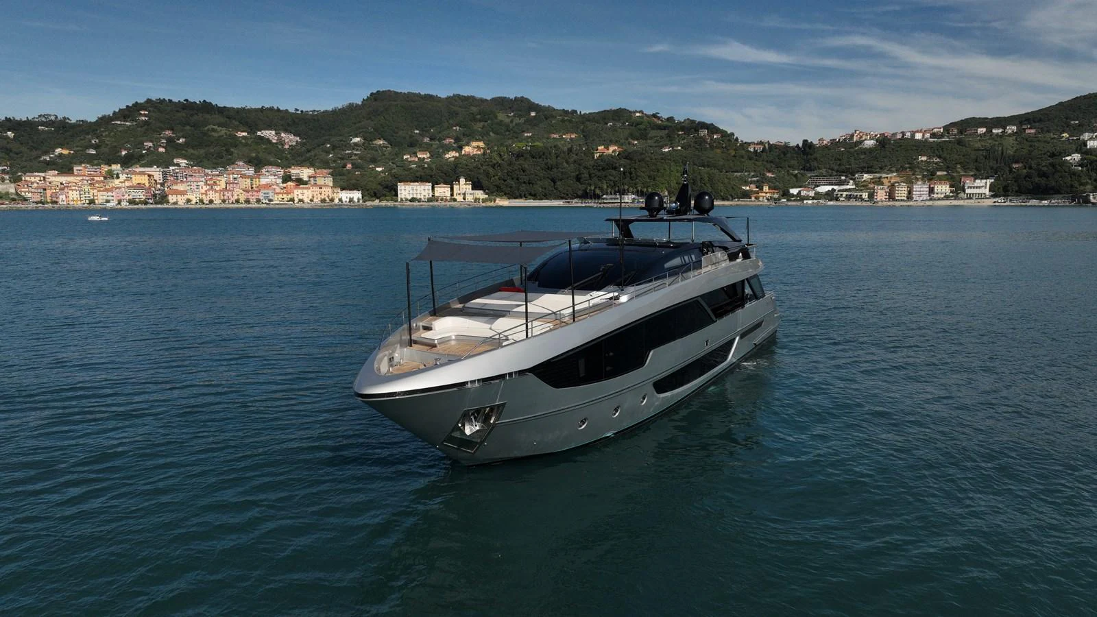 A sleek and modern yacht glides gracefully on calm waters with a scenic coastal backdrop. aboard GIO4 Yacht for Sale