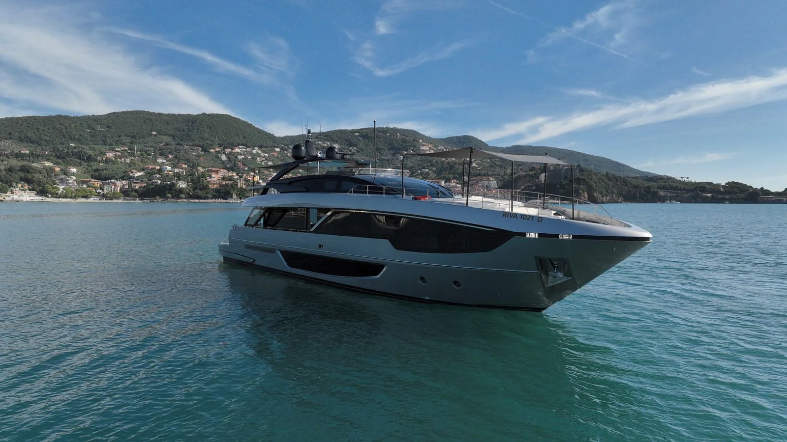 A sleek and modern yacht glides gracefully on calm waters with a scenic coastal backdrop. aboard GIO4 Yacht for Sale