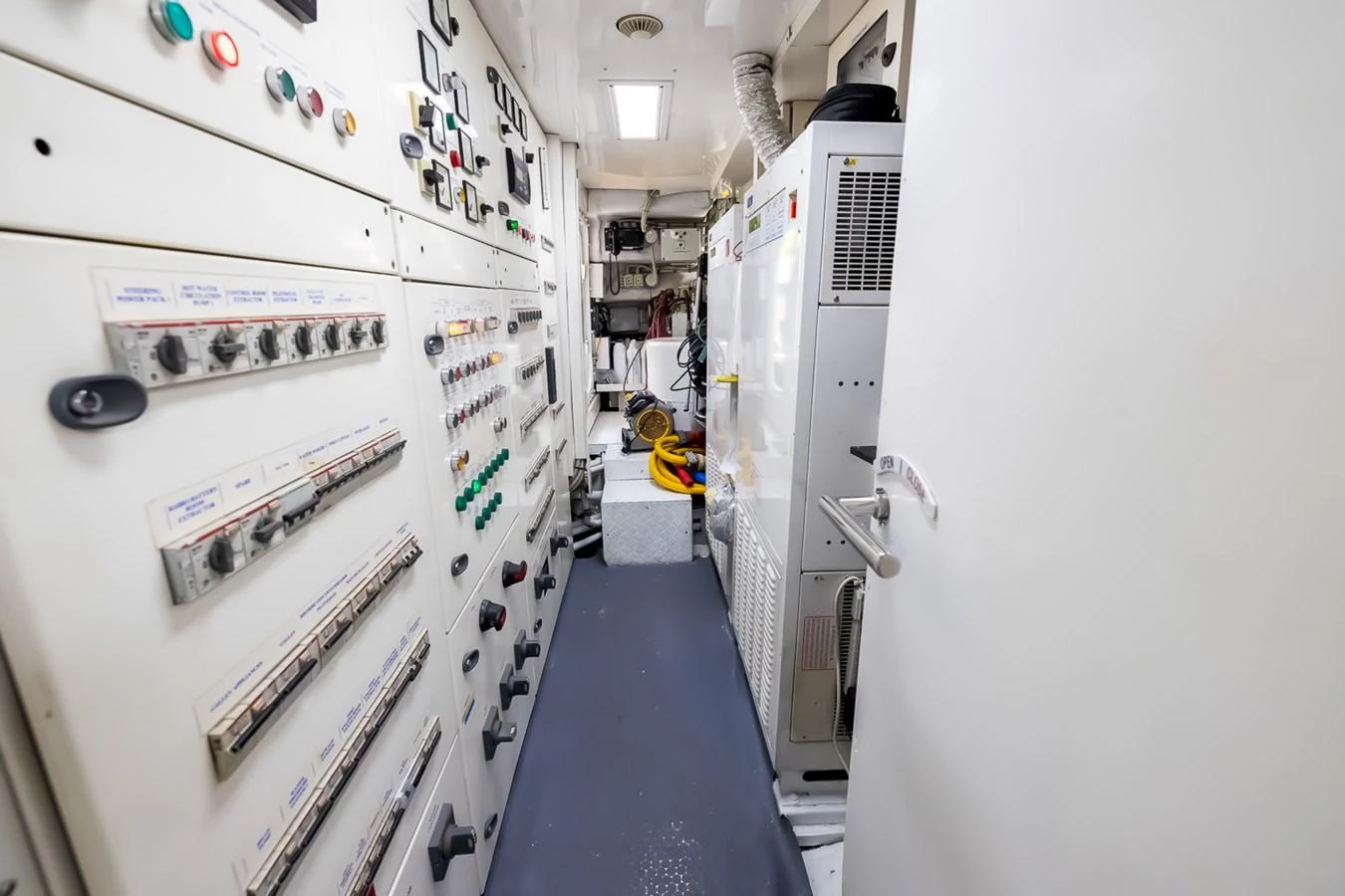The image showcases the yacht's engine room with various control panels and equipment. aboard GOTTA GO Yacht for Sale