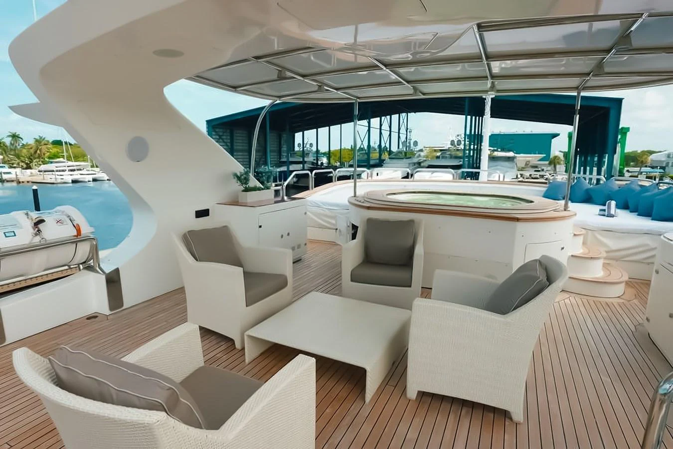 The sundeck features a luxurious seating area with a hot tub, perfect for relaxation and entertainment. aboard GOTTA GO Yacht for Sale