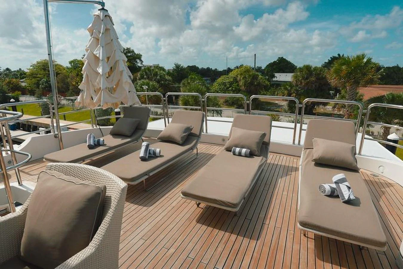 The sundeck features comfortable lounge chairs and a parasol, perfect for relaxation under the sun. aboard GOTTA GO Yacht for Sale