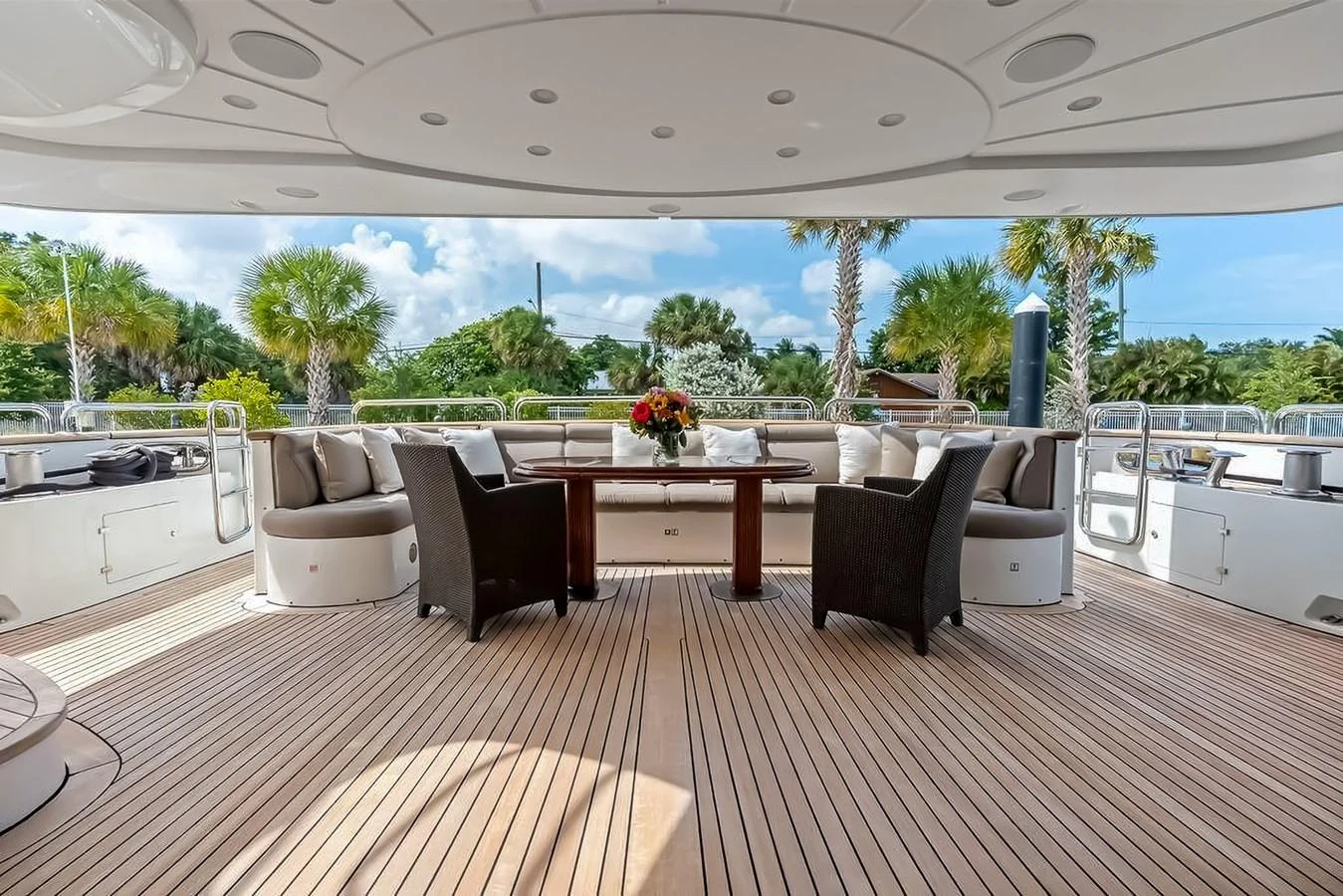 The aft deck features a spacious seating area with a dining table, perfect for alfresco dining and relaxation. aboard GOTTA GO Yacht for Sale