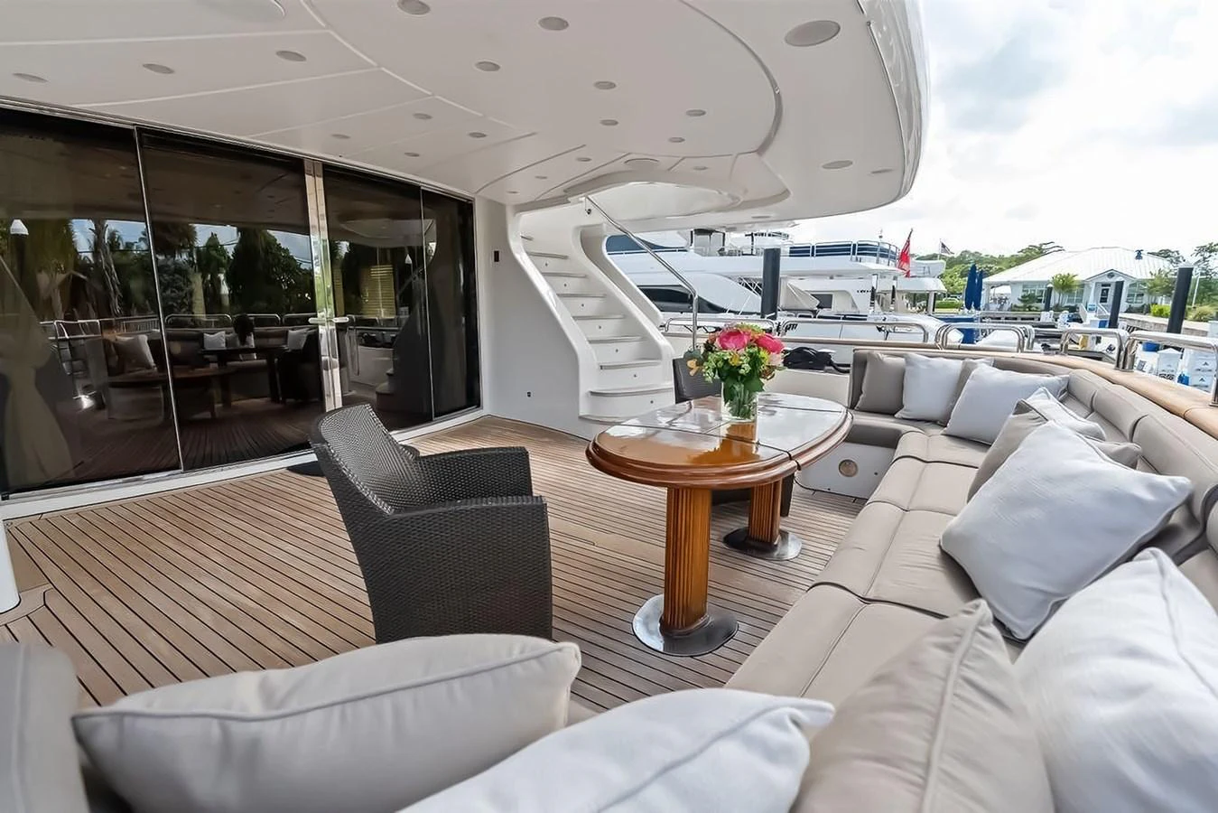 The aft deck features a spacious seating area with a table and comfortable cushions, perfect for outdoor relaxation. aboard GOTTA GO Yacht for Sale