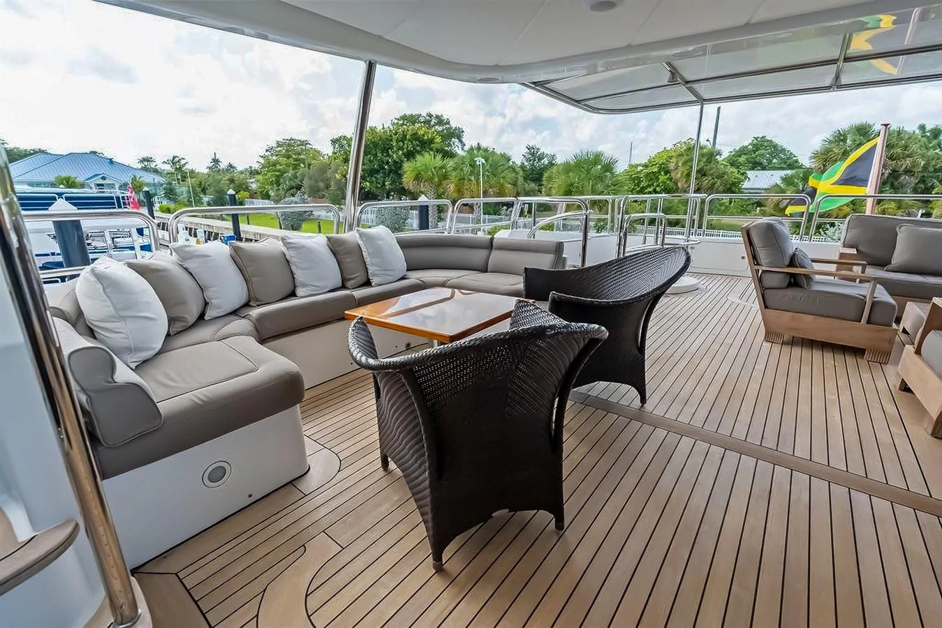 The aft deck features a spacious seating area with comfortable cushions and a stylish wooden table, perfect for relaxation and socializing. aboard GOTTA GO Yacht for Sale
