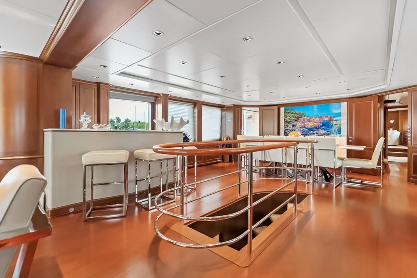 The yacht's interior features a spacious and elegant dining and lounge area with modern furnishings and ample natural light. aboard GOTTA GO Yacht for Sale