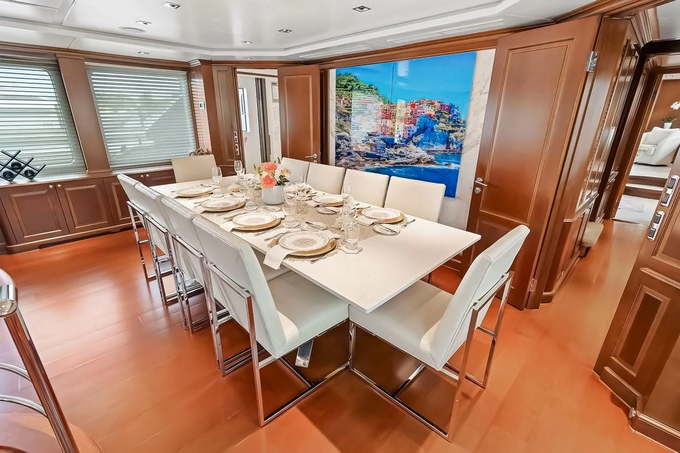 The yacht's dining area features a modern table set for a meal, surrounded by comfortable seating and elegant decor. aboard GOTTA GO Yacht for Sale