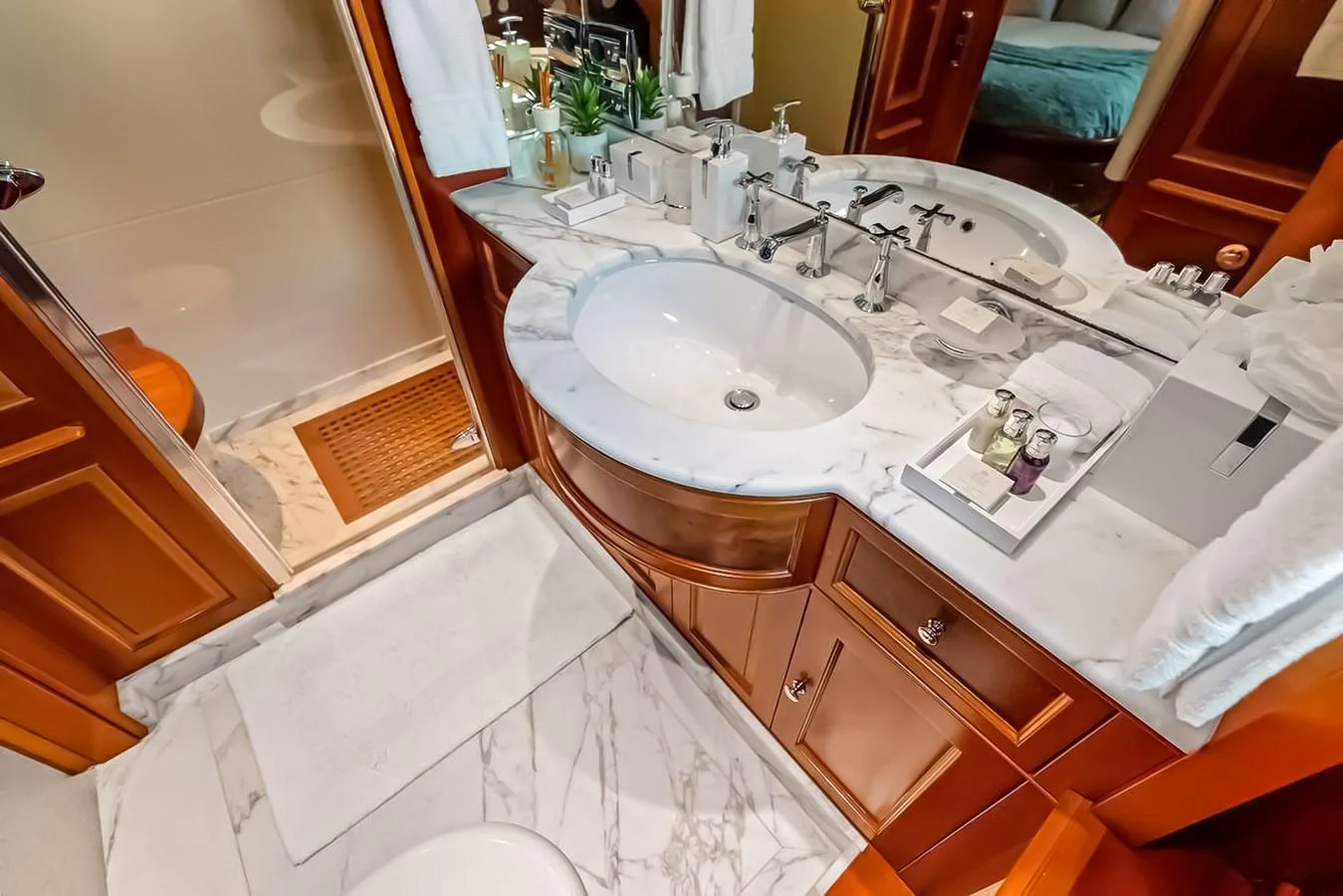 A luxurious yacht bathroom featuring dual sinks and elegant wooden cabinetry. aboard GOTTA GO Yacht for Sale