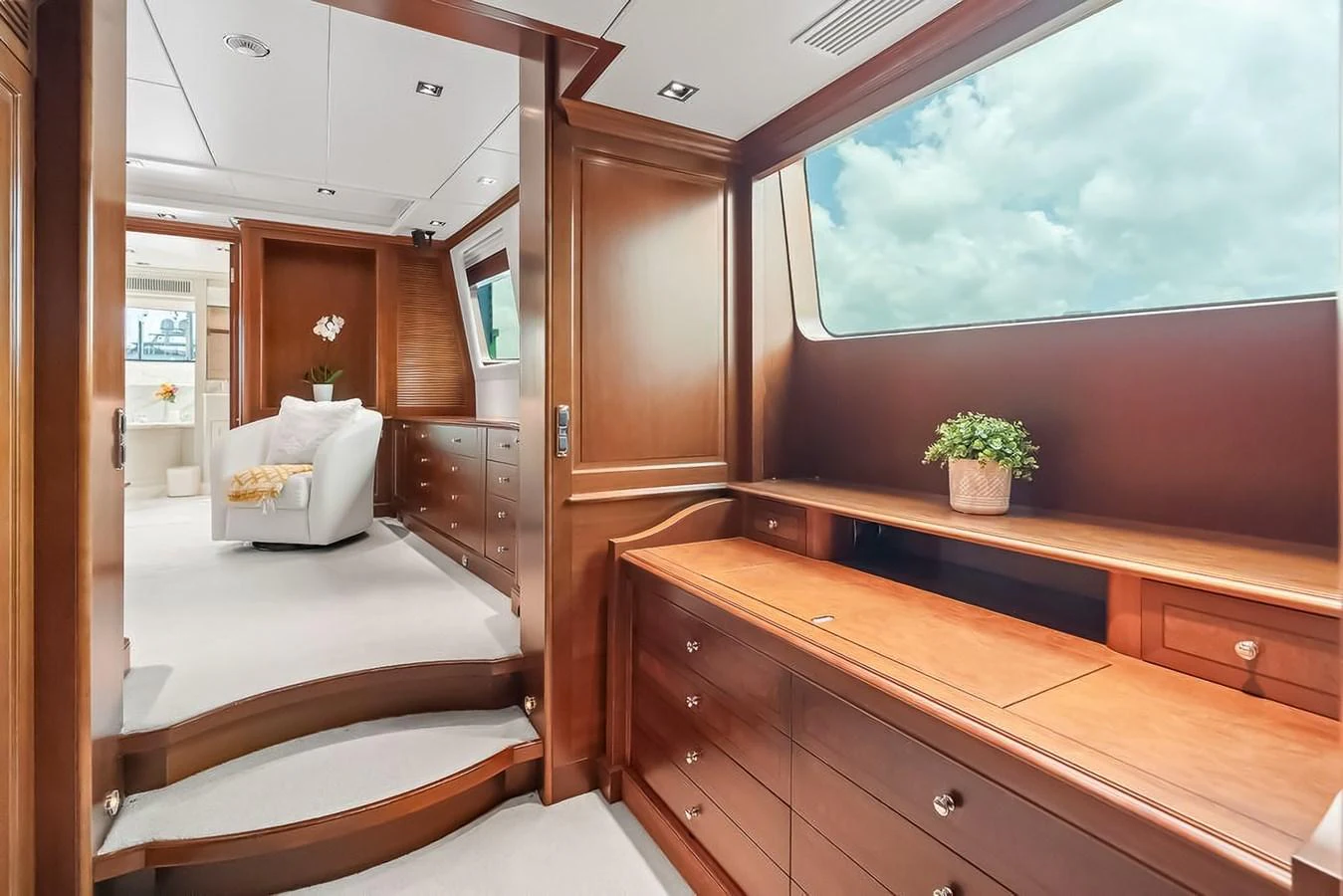 The yacht's interior features elegant wooden cabinetry and large windows offering a bright and airy atmosphere. aboard GOTTA GO Yacht for Sale