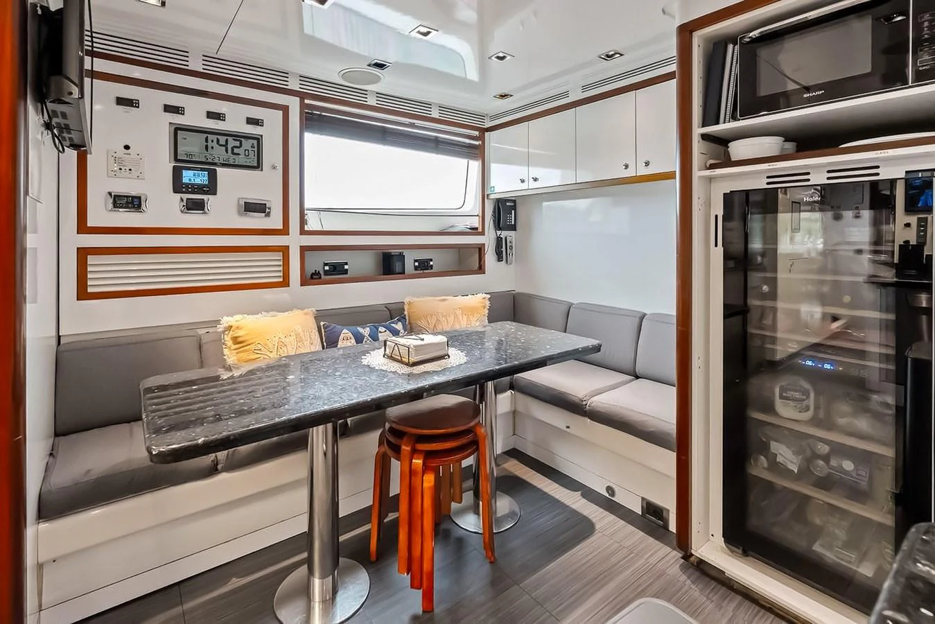 The galley features a cozy dining area with modern appliances and ample seating. aboard GOTTA GO Yacht for Sale