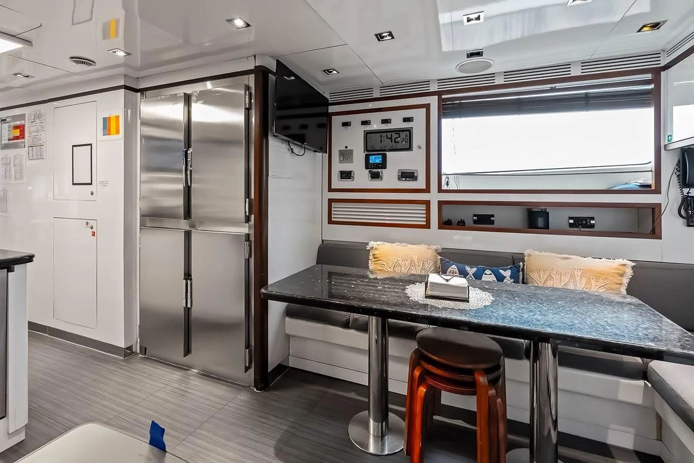 The galley features a sleek dining area with modern appliances and comfortable seating. aboard GOTTA GO Yacht for Sale