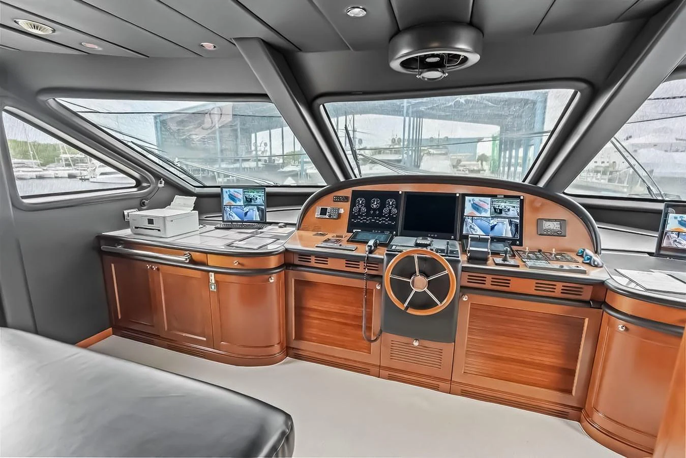 The helm station features advanced navigation equipment and luxurious wood finishes. aboard GOTTA GO Yacht for Sale