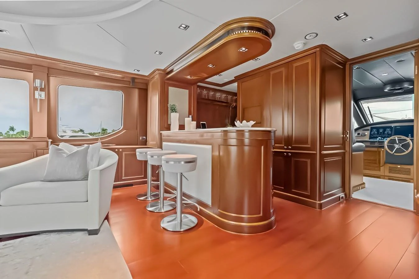 The yacht's salon features a stylish bar area with modern stools and luxurious wood finishes. aboard GOTTA GO Yacht for Sale