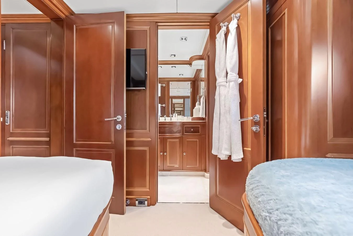 This inviting stateroom features warm wood paneling and a private ensuite bathroom. aboard GOTTA GO Yacht for Sale