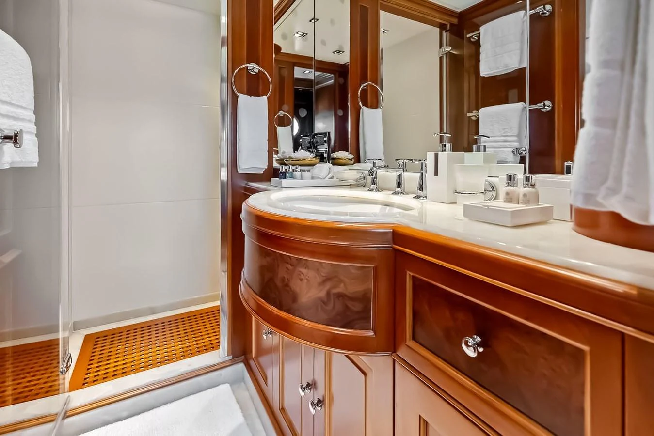 The bathroom features elegant wood cabinetry and a spacious shower area. aboard GOTTA GO Yacht for Sale