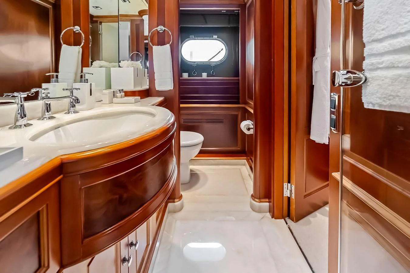 The yacht's bathroom features elegant wood finishes and modern fixtures. aboard GOTTA GO Yacht for Sale