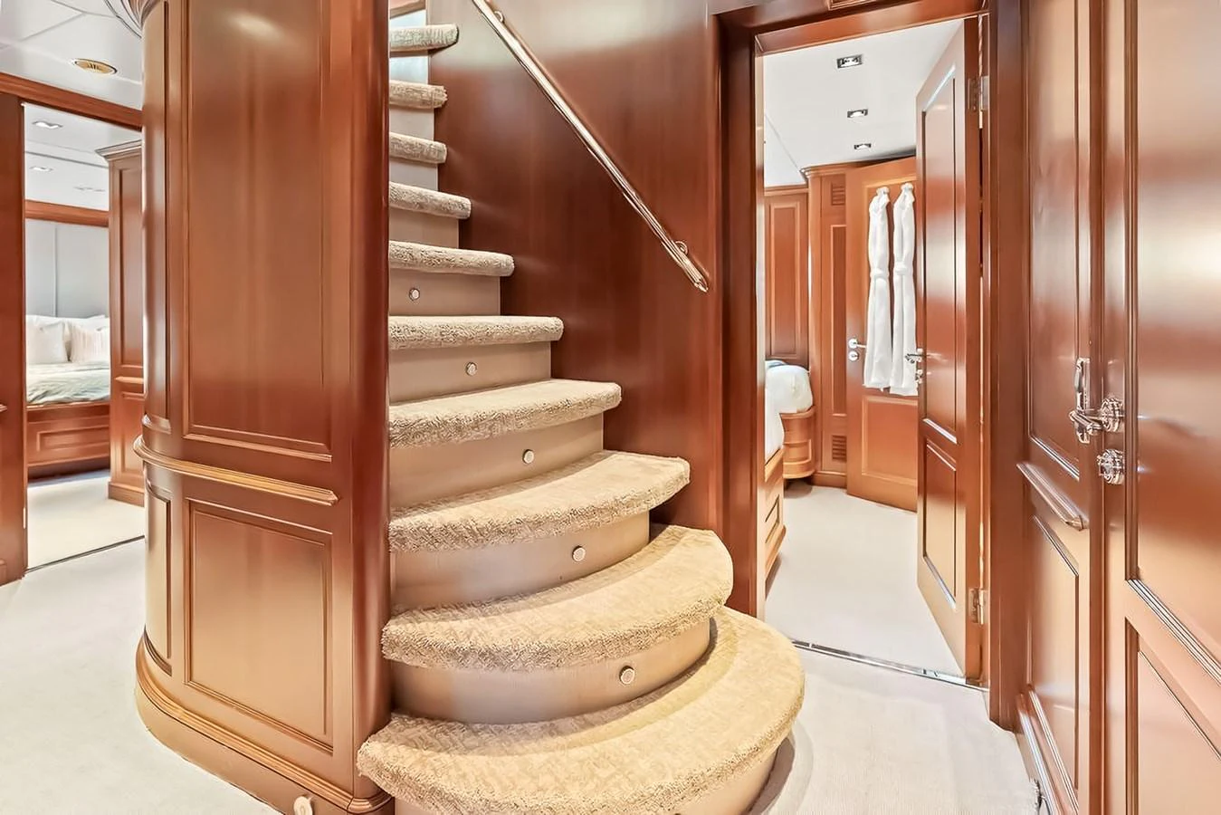 Elegant wooden staircase leading to luxurious staterooms. aboard GOTTA GO Yacht for Sale