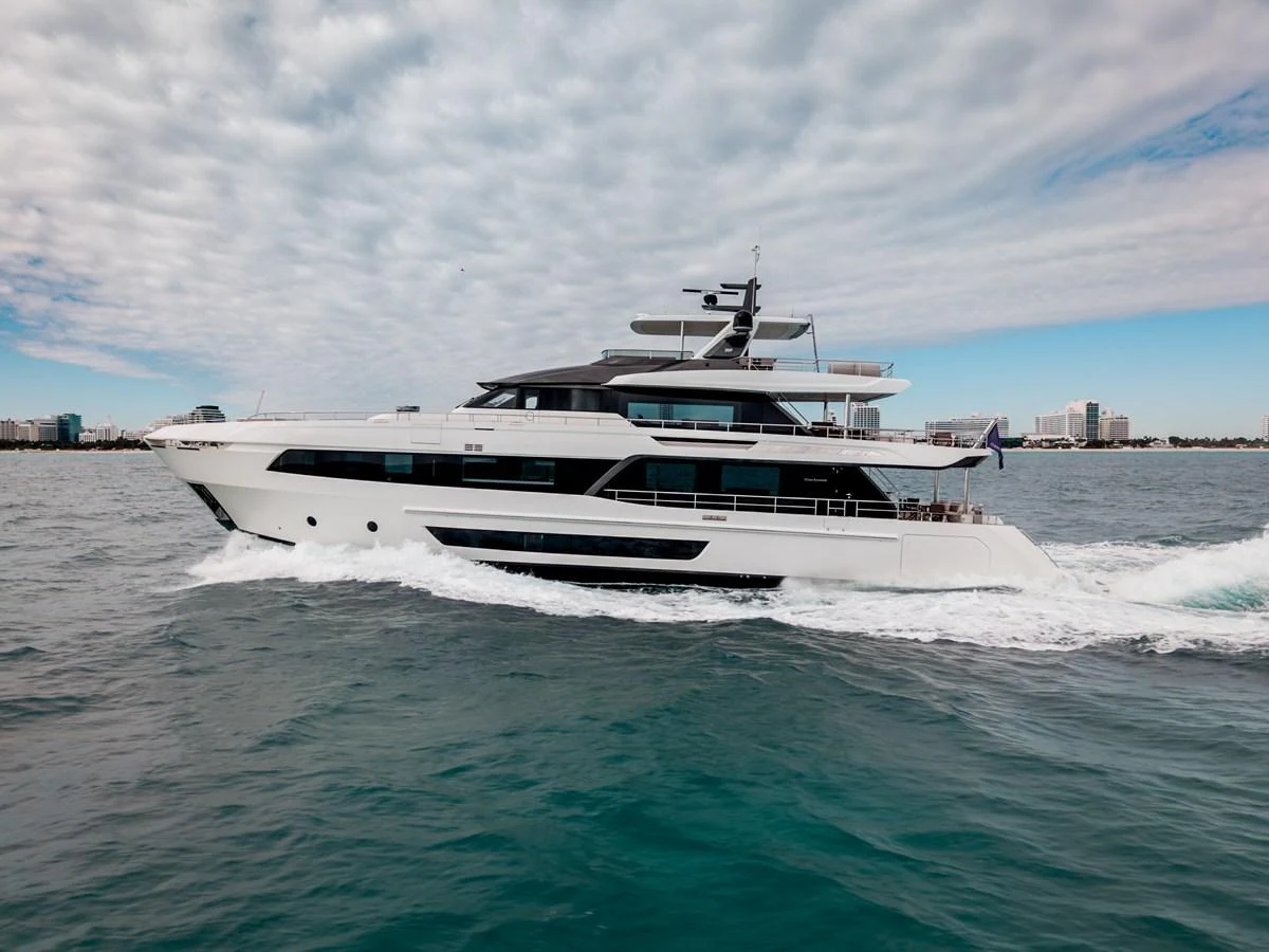 A sleek and modern yacht glides through the water under a partly cloudy sky. aboard OCEAN ALEXANDER 35P05 Yacht for Sale