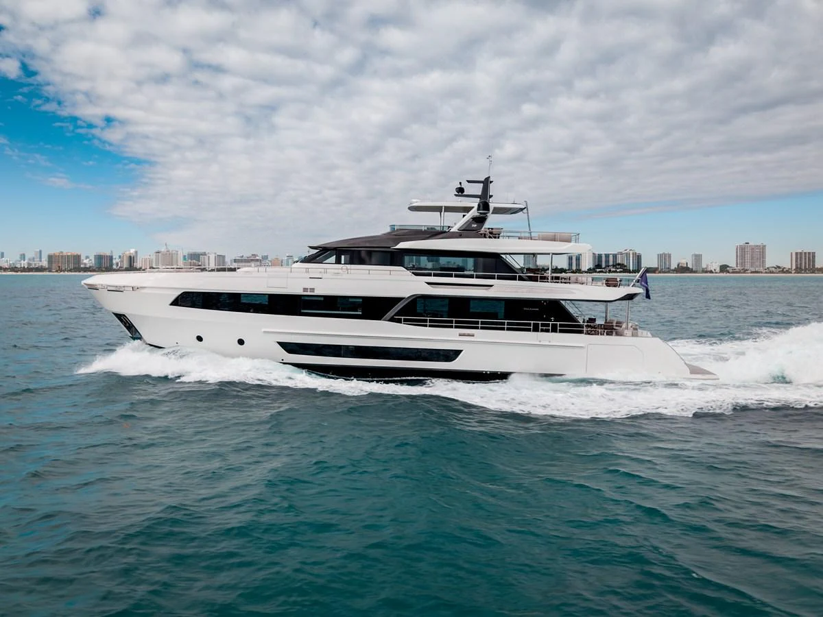 A sleek and modern yacht cruises through the water with a city skyline in the background. aboard OCEAN ALEXANDER 35P05 Yacht for Sale