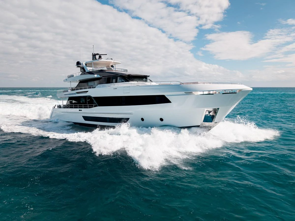 A sleek and modern yacht cruises swiftly through the open sea under a partly cloudy sky. aboard OCEAN ALEXANDER 35P05 Yacht for Sale