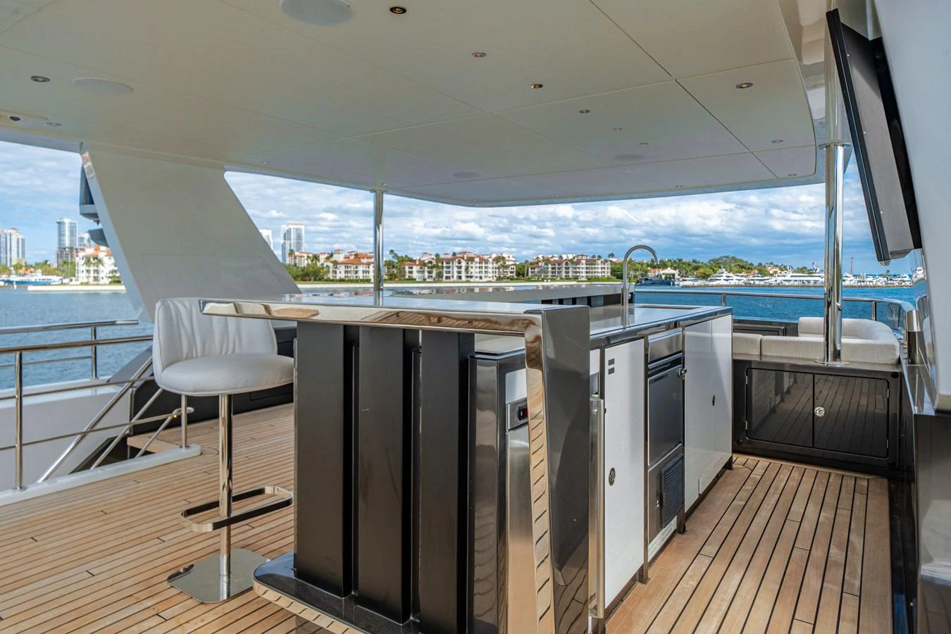 The flybridge features a sleek bar area with modern seating and panoramic views. aboard OCEAN ALEXANDER 35P05 Yacht for Sale