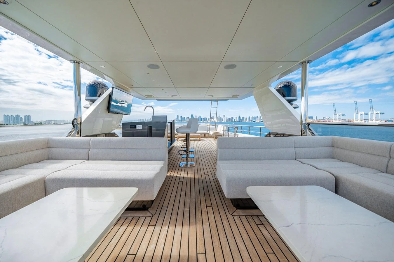 The aft deck features spacious seating with a stunning view of the city skyline. aboard OCEAN ALEXANDER 35P05 Yacht for Sale