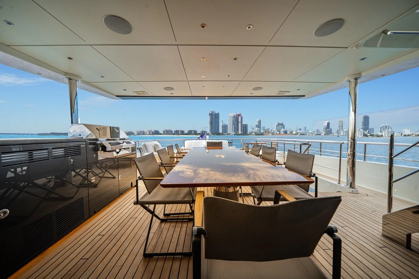 The aft deck offers a spacious and elegant dining area with stunning views of the city skyline. aboard OCEAN ALEXANDER 35P05 Yacht for Sale