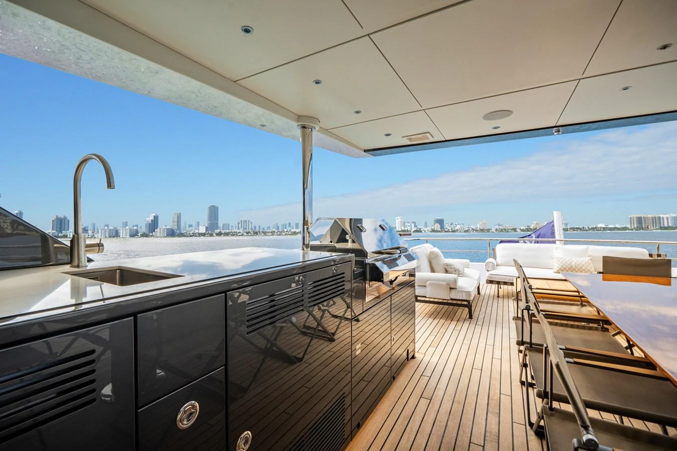The aft deck offers a luxurious outdoor dining and lounging area with stunning views of the city skyline. aboard OCEAN ALEXANDER 35P05 Yacht for Sale