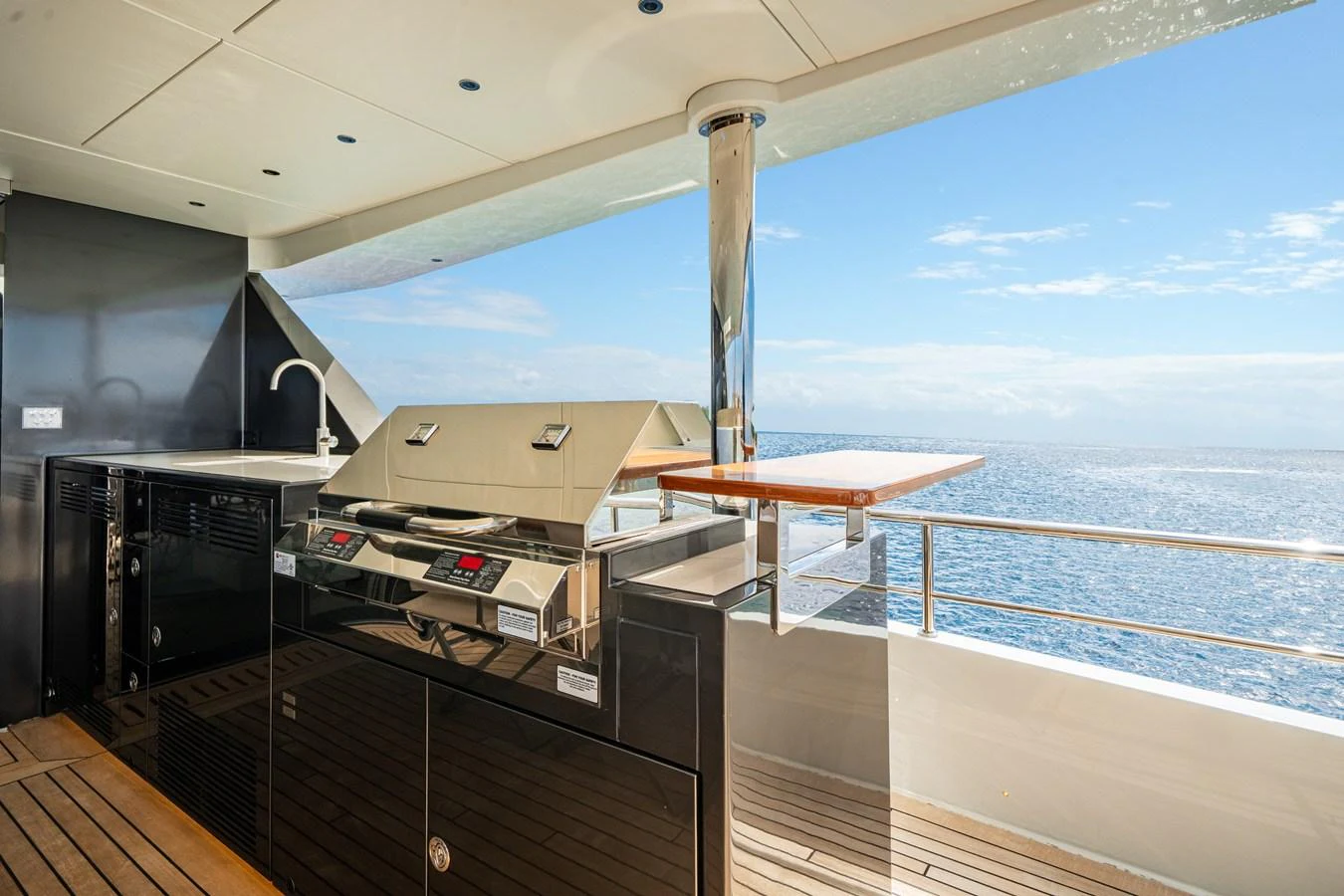 The yacht features a sleek outdoor kitchen with a grill and stunning ocean views. aboard OCEAN ALEXANDER 35P05 Yacht for Sale